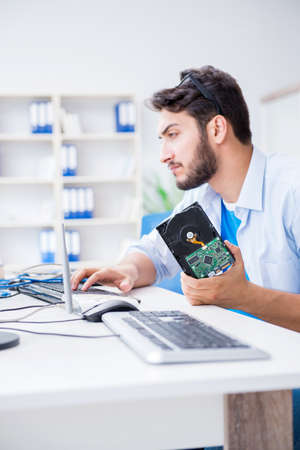 Technician with broken hard drive