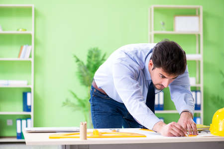 Young male architect working at the projectの写真素材