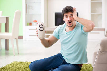 Young man struggling with personal finance and bills
