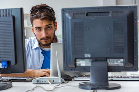 IT technician looking at IT equipment