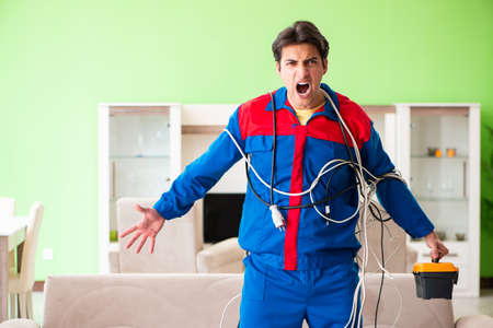 Electrician contractor with tangled cablesの写真素材