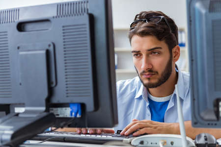 IT technician looking at IT equipment