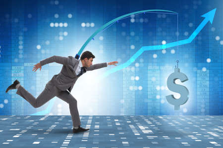 Businessman chasing money on fishing rodの写真素材