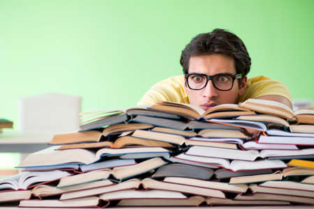 Student with too many books to read before examの写真素材