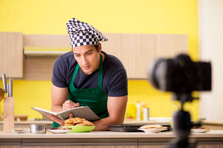 Young chef blogger explaining food preparationの写真素材