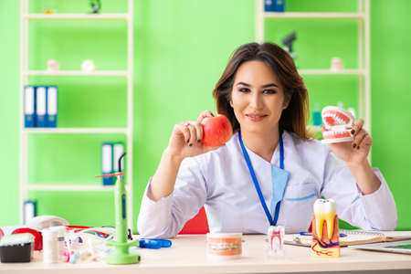 Woman dentist working on teeth implantの写真素材