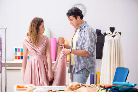 Young tailor working in his workshopの写真素材