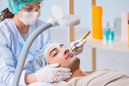 Man visiting dermatologyst for laser scar removalの写真素材