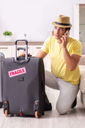 Man going on vacation with fragile suitcasesの写真素材