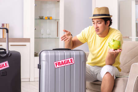 Man going on vacation with fragile suitcasesの写真素材