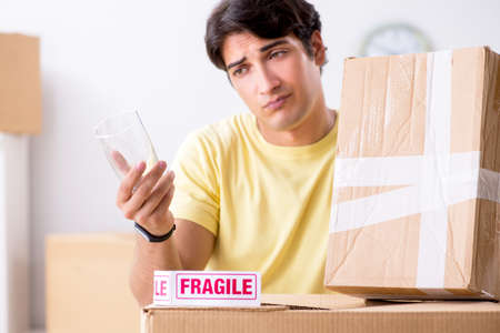 Man moving house and relocating with fragile itemsの写真素材