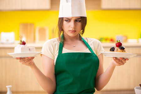 Young cook cooking cakes in the kitchenの写真素材