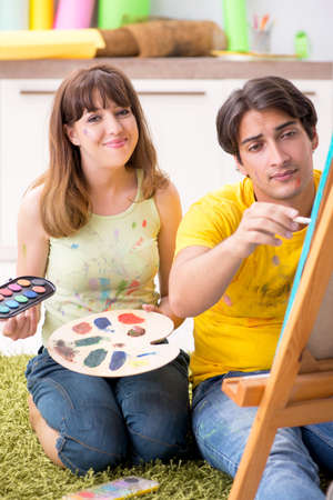 Young couple enjoying painting at homeの写真素材