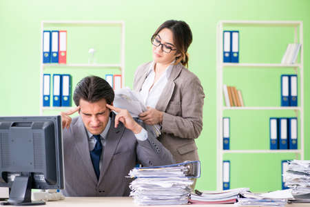 Man employee suffering from excessive workの写真素材