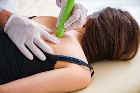 Patient in clinic undergoing laser scar removal