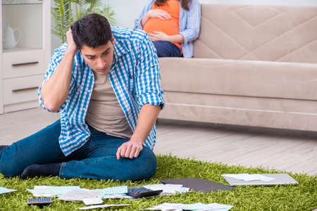 Young family in budget planning concept