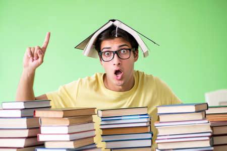 Student with too many books to read before examの写真素材