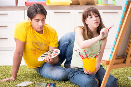 Young couple enjoying painting at home