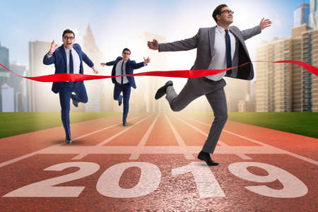 Businessman on finishing line in race for 2019の写真素材