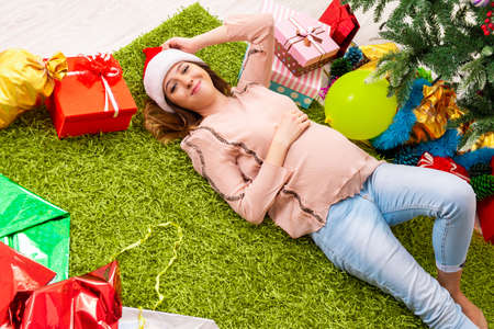 Pregnant wife celevrating christmas with husbandの写真素材