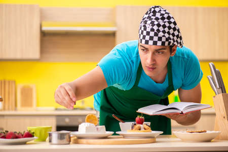 Man cook preparing cake in kitchen at homeの写真素材