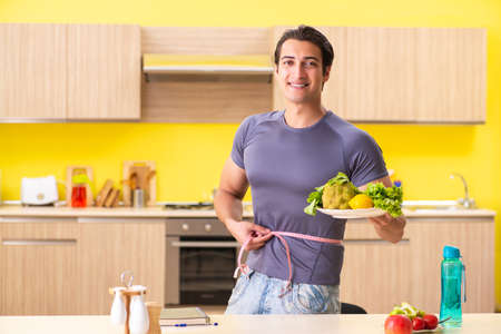 Young man in dieting and healthy eating conceptの写真素材