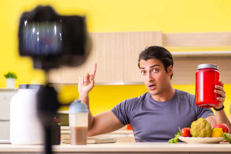 Young man blogging about food supplementsの写真素材