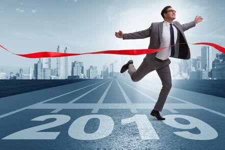 Businessman on finishing line in race for 2019の写真素材