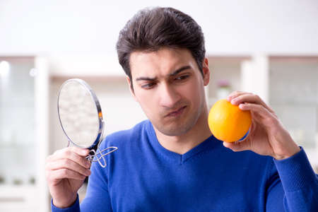 Young handsome man taking care of face skinの写真素材