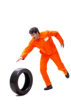 Young garage worker with tyre isolated on whiteの写真素材