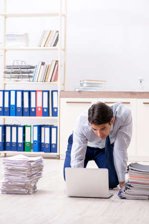 Extremely busy employee working in the officeの写真素材