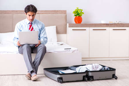 Young handsome businessman preparing for tripの写真素材