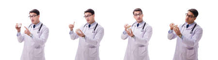 Yong male doctor with skeleton isolated on whiteの写真素材
