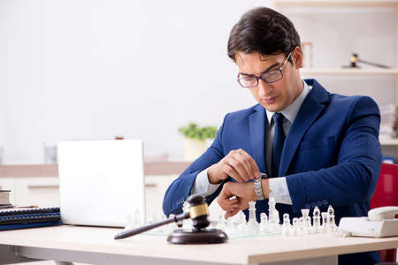 Young lawyer playing chess to train his court strategy and tactiの写真素材