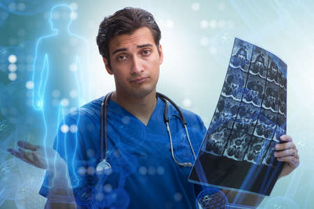 Young doctor looking at x-ray image in mhealth concept