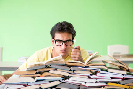 Student with too many books to read before exam