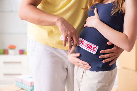 Young couple moving to new flat with fragile things