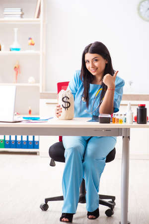 Young beautiful female doctor working in the clinicの写真素材