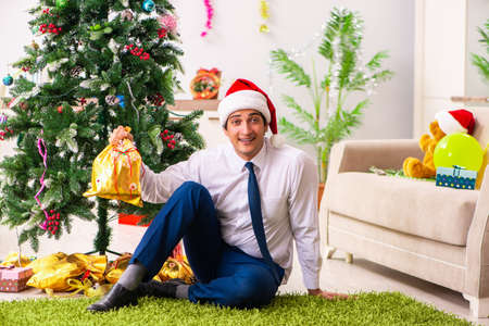 Employee businessman celebrating christmas in officeの写真素材