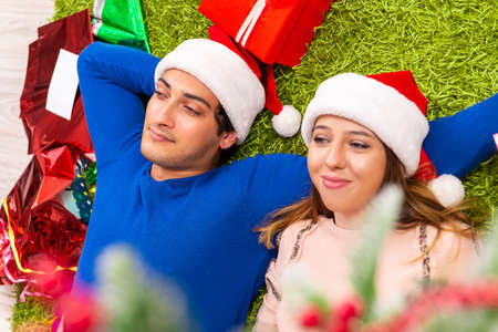 Pregnant wife celevrating christmas with husbandの写真素材