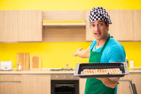 Man cook preparing cake in kitchen at homeの写真素材