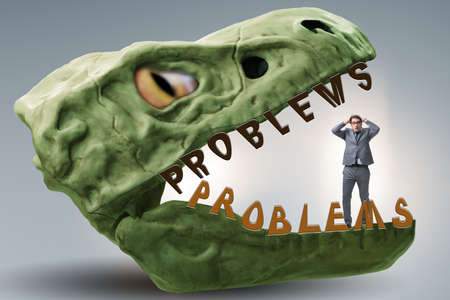 Businessman in the jaws of problemsの写真素材