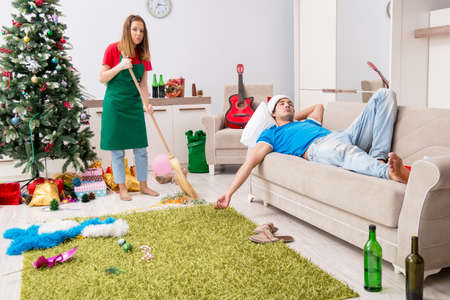 Young family cleaning apartment after christmas partyの写真素材
