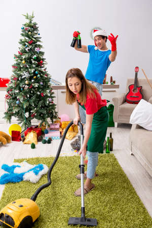 Young family cleaning apartment after christmas partyの写真素材