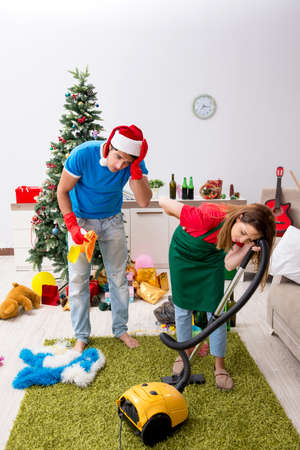 Young family cleaning apartment after christmas partyの写真素材