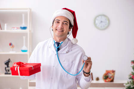 Doctor with gift box in the hospitalの写真素材