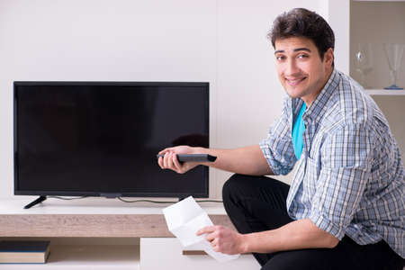 Man trying to fix broken tv