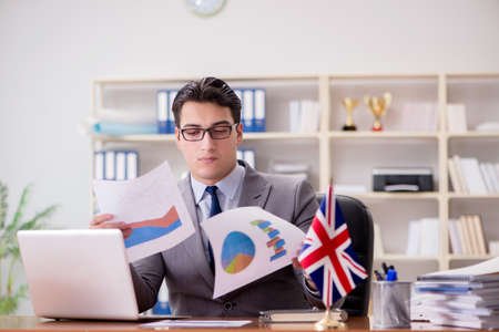 Businessman with British flag in the officeの写真素材