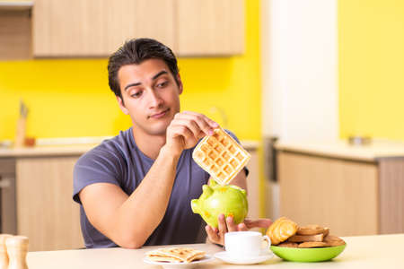Young man in unhealthy food conceptの写真素材