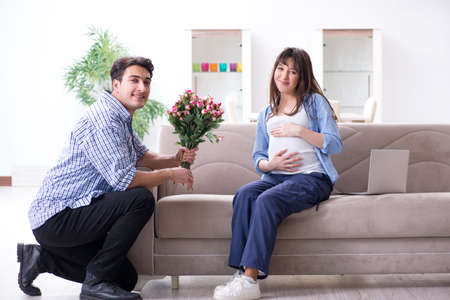 Happy family celebrating pregnancy at homeの写真素材